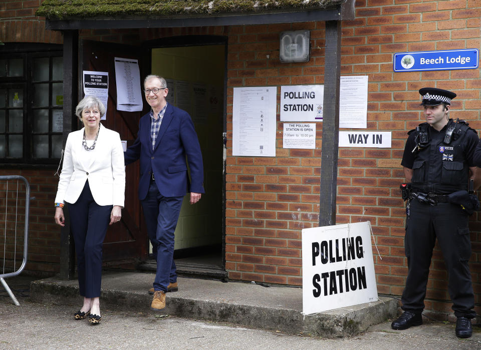 Britain’s Prime Minister Theresa May leaves with her husband Philip after voting in the general election at polling station in Maidenhead, England, Thursday, June 8, 2017. (AP Photo/Alastair Grant)