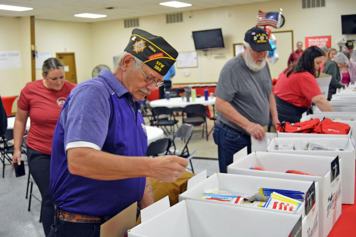 Columbia VFW Post 280 Commander Ed Miller fills an Operation Gratitude care kit Thursday at Columbia American Legion Post 202. The sundry items in the care kits will be sent to those currently deployed.