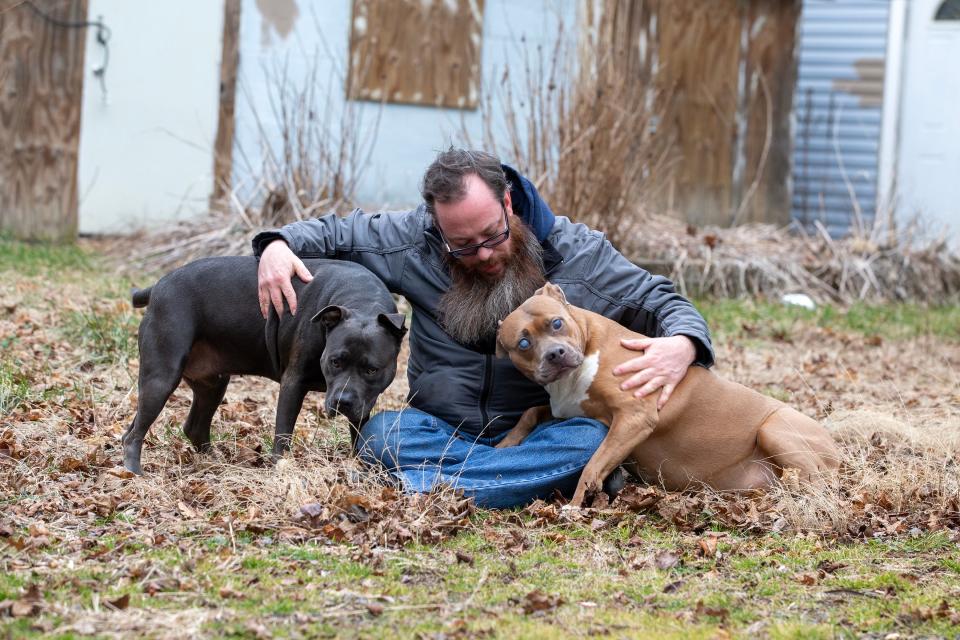 Richard Osthoff, a Howell veteran who accused New York Rep. George Santos of using an alias and scamming him out of money raised for his dying dog, plays with his dogs, Diamond and Ruby, at his current residence in Freehold, NJ Monday, February 6, 2023. 