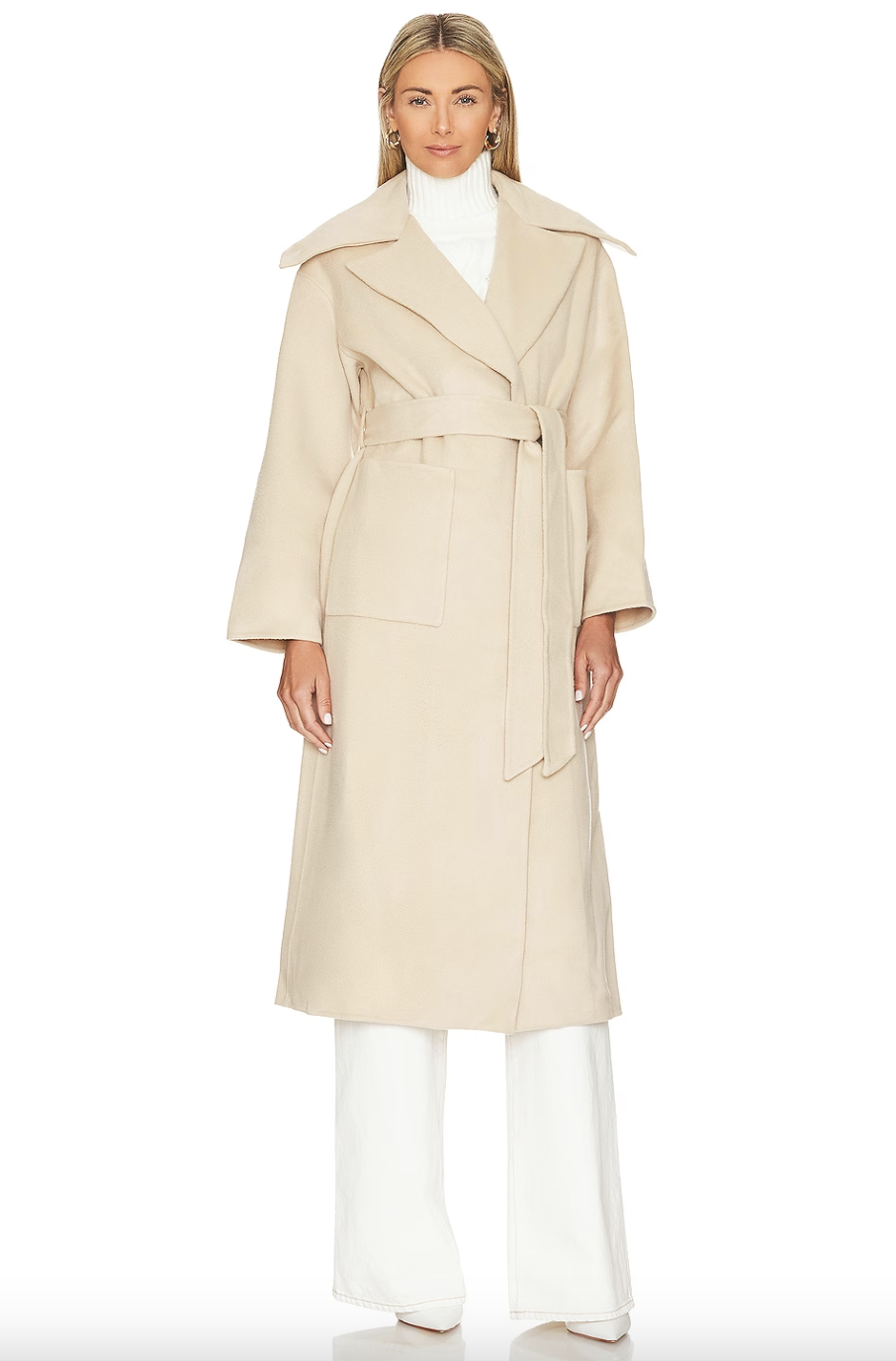 model in white pants and light beige belted Bubish Willow Coat (photo via Revolve)