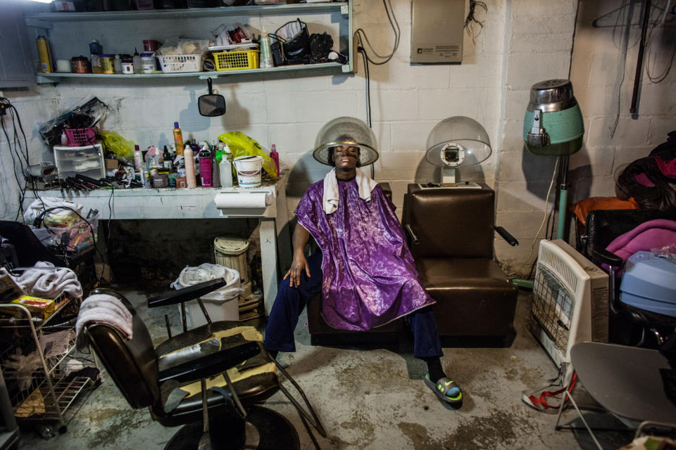 <p>Olympic Gold Medal Boxer Claressa “T-Rex” Shields finishes having her hair done in the basement studio of Miss Paula, a women that she once lived with in Flint. Claressa has lived all over Flint, with a grip of different people but she is now fairly settled in with her coach Jason Crutchfield. (Photograph by Zackary Canepari) </p>