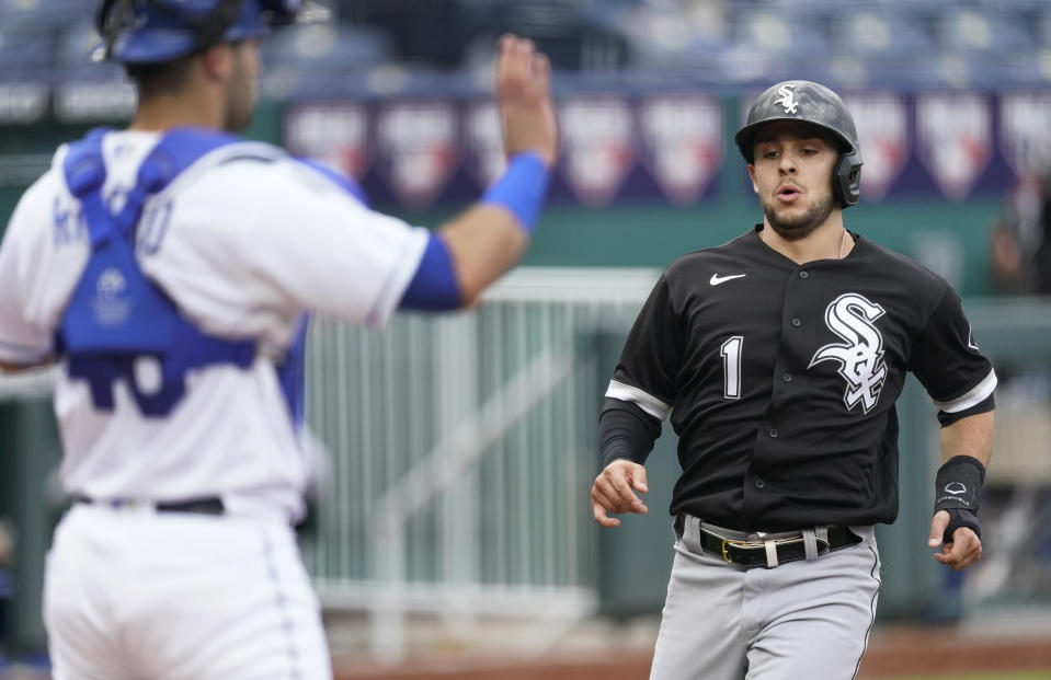 Chicago White Sox's Nick Madrigal runs home to score past Kansas City Royals catcher Sebastian Rivero on a double by Yoan Moncada during the first inning of a baseball game Saturday, May 8, 2021, in Kansas City, Mo. (AP Photo/Charlie Riedel)