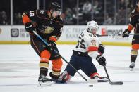 Anaheim Ducks center Derek Grant, left, and Florida Panthers defenseman Aaron Ekblad battle for the puck during the first period of an NHL hockey game Wednesday, Feb. 19, 2020, in Anaheim, Calif. (AP Photo/Mark J. Terrill)