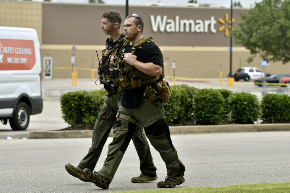 Sheriff Deputies walk through the parking lot after a shooting at a Walmart store Tuesday, July 30, 2019 in Southaven, Miss. A gunman fatally shot two people and wounded a police officer before he was shot and arrested Tuesday at the Walmart in northern Mississippi, authorities said. (Photo: Brandon Dill/AP)