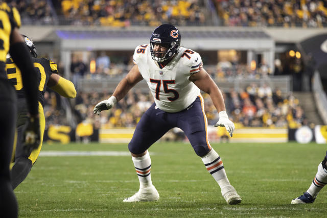 Chicago Bears offensive tackle Larry Borom (75) runs off the field after an  NFL football game