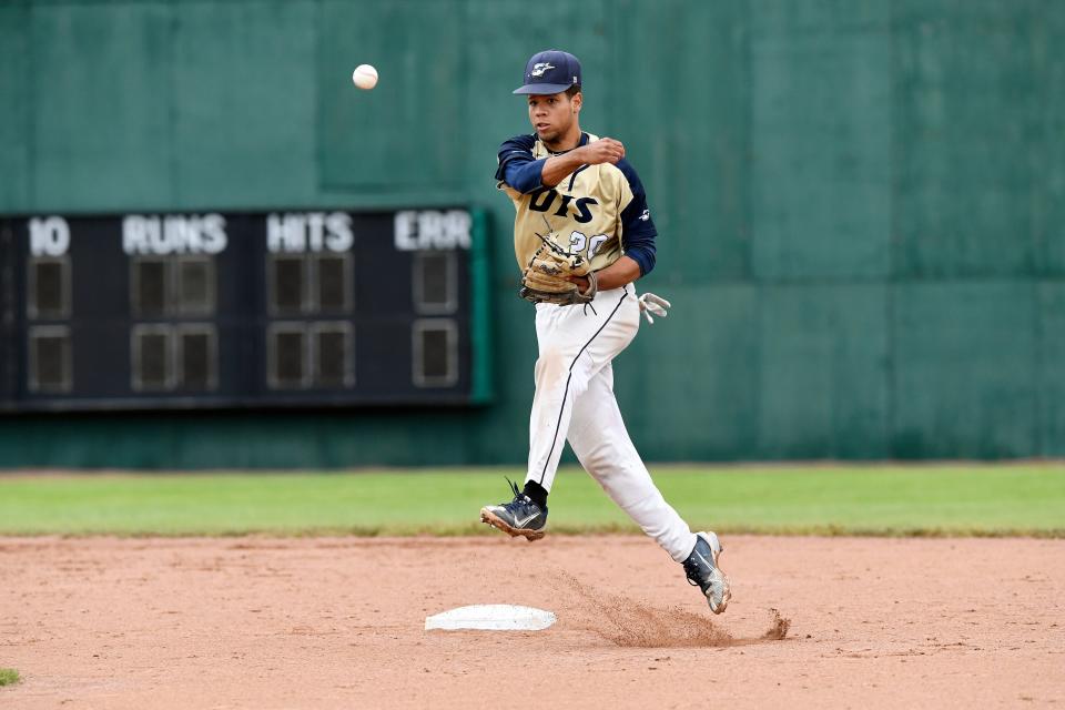 University of Illinois Springfield infielder Zion Pettigrew tosses the ball to first base against host Wayne State in the NCAA Division II Midwest Regional final on Sunday, May 22.