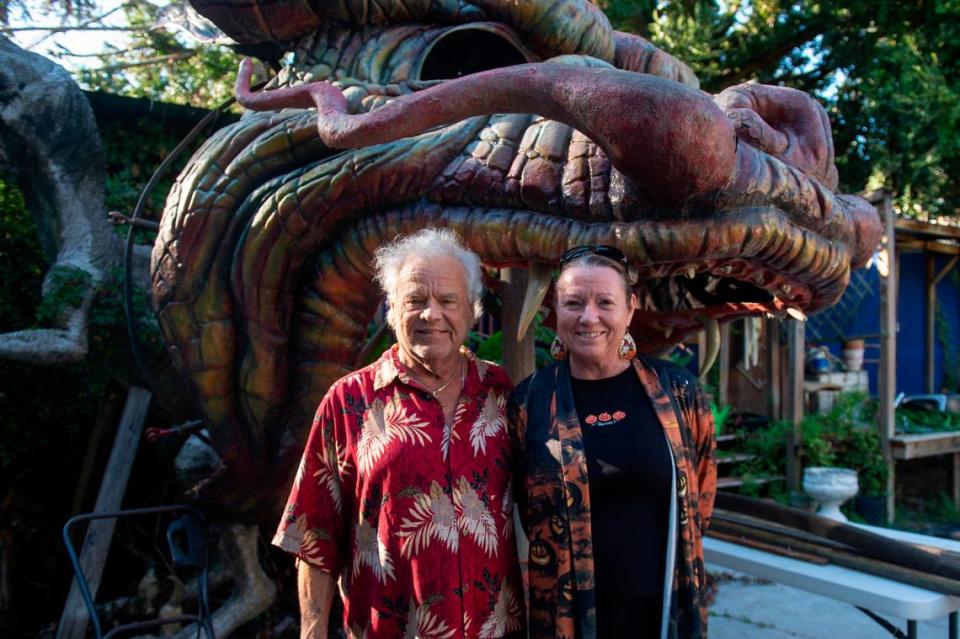 Frank and Marlene Gann stand in front of the Lady Luck Casino dragon in their backyard on Tuesday, Oct. 17, 2023. The Ganns rescued the dragon from being trashed when the Lady Luck Casino closed in the late 90s.