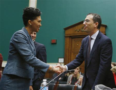 Cheryl Campbell (L), Senior Vice President of CGI Federal meets Andrew Slavitt, Executive Vice President for Optum/QSSI during a House Energy and Commerce Committee hearing on the Patient Protection and Affordable Care Act on Capitol Hill in Washington, October 24, 2013. REUTERS/Jason Reed