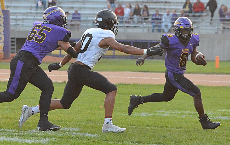 Watertown running back Juven Hudson (8) attempts to turn the corner against Sioux Falls Washington's Dontai Smith during Watertown High School's homecoming football game on Friday, Sept. 15, 2023 at Watertown Stadium. At left is Watertown's Jayden Lambert.