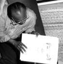 <p>Miles Davis shows off his sketchbook backstage in London in 1983. How else would you expect the famed jazz trumpeter to decompress? </p>