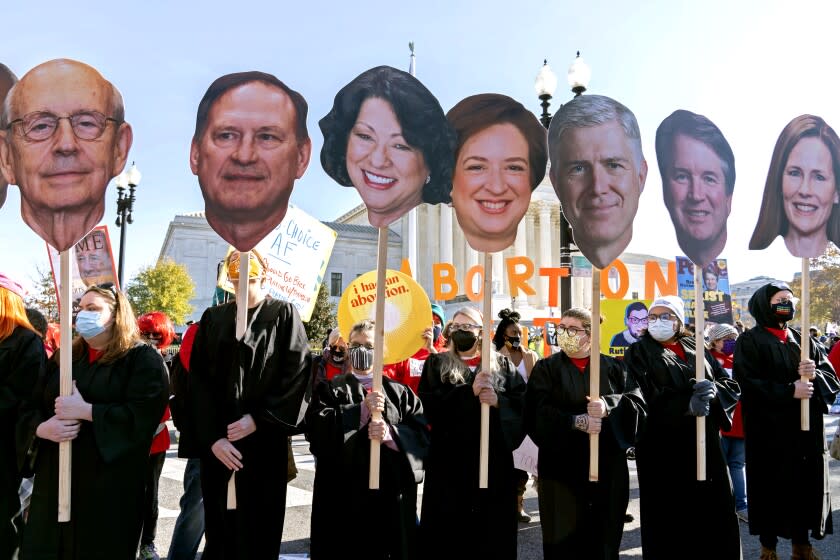 Abortion rights advocates holding cardboard cutouts of the Supreme Court Justices, demonstrate in front of the U.S. Supreme Court Wednesday, Dec. 1, 2021, in Washington, as the court hears arguments in a case from Mississippi, where a 2018 law would ban abortions after 15 weeks of pregnancy, well before viability. (AP Photo/Jose Luis Magana)