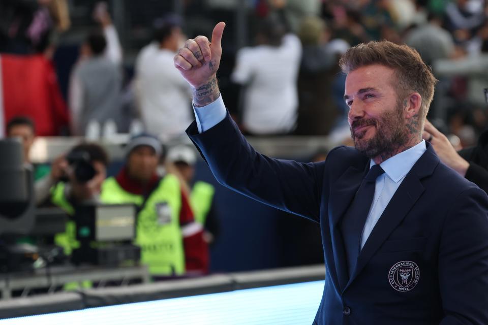 David Beckham signals to the crowd as he enters the pitch prior to the match between Inter Miami and the Galaxy.
