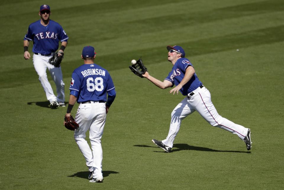 Drew Robinson (68) comes dangerously close to wearing a banned number with the Rangers in spring training. (AP Photo/Matt York)