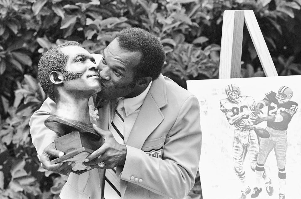 FILE - In this Aug. 2, 1980, file photo, former Green Bay Packers cornerback Herb Adderley hugs his statue after enshrinement in the Pro Football Hall of Fame in Canton, Ohio. Hall of Fame cornerback Herb Adderley has died. He was 81. His death was confirmed Friday, Oct. 30, 2020, on Twitter by nephew Nasir Adderley, a safety for the Los Angeles Chargers. Adderley played on six NFL title teams over a 12-year career with Green Bay and Dallas. (AP Photo/File)