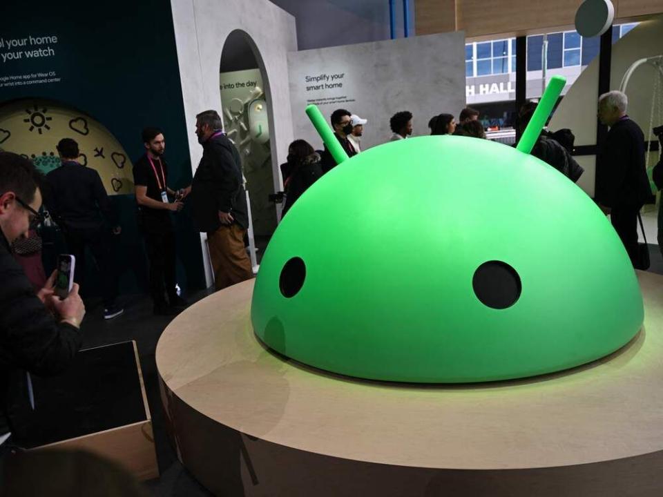  Attendees take pictures of a large Android logo head at Alphabet’s Google Android plaza booth during the Consumer Electronics Show (CES) in Las Vegas, Nev., in January.