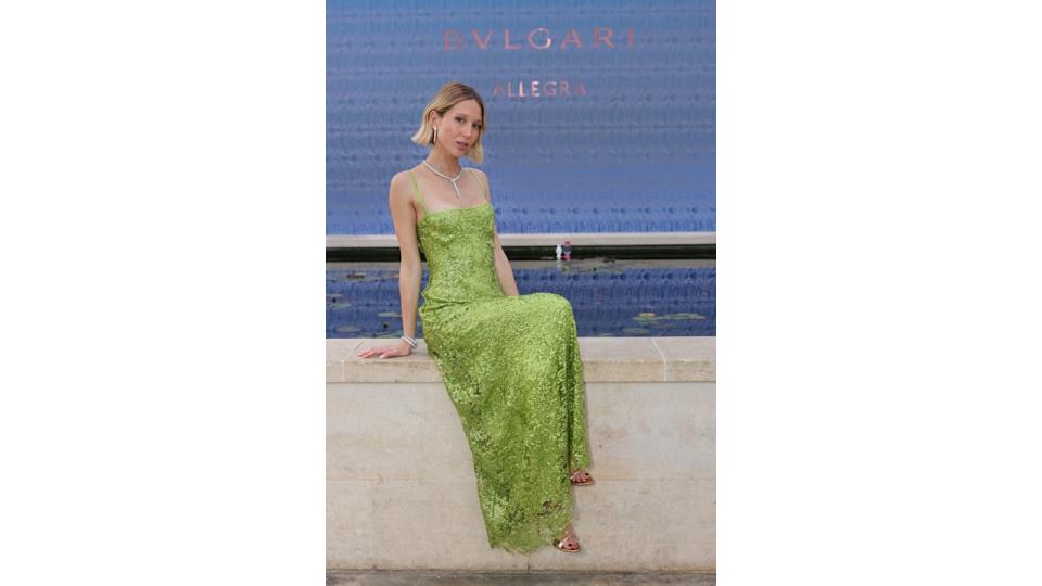 Princess Olympia posing on wall in apple green green