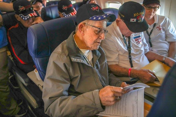 A veteran reads a letter during a mail-call session on the 2019 Texas South Plains Honor Flight.