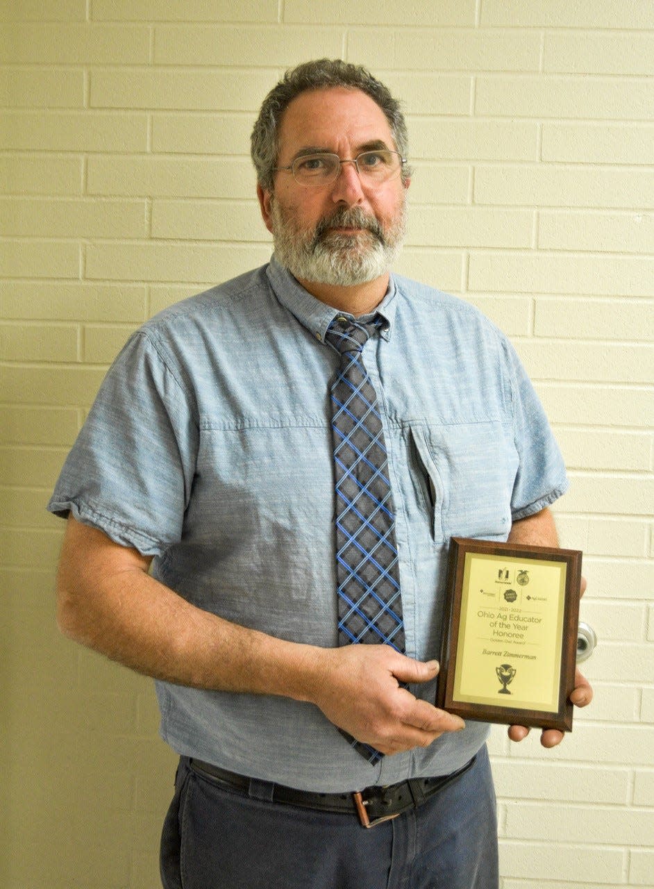 2991 Clyde High School agriculture teacher Barrett Zimmerman holds his Golden Owl Award which he earned as one of 10 Ohio teachers chosen as a finalist for the 2021-2022 Ag Educator of the Year.