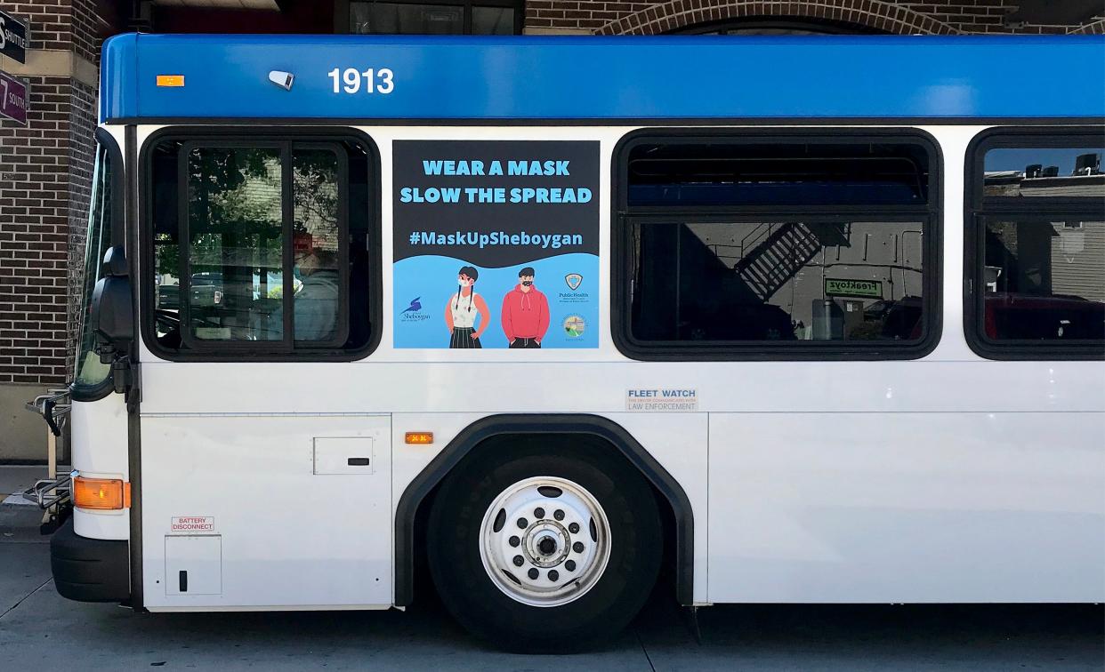 A Shoreline Metro bus has a mask advocating ad on its side as it waits at the transfer station downtown, Sept. 18, 2020, in Sheboygan, Wis.