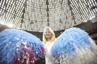 Pam Carlson, 54, a former cheerleader for the Houston Oilers from 1982-84, carries pom poms as she celebrates with others the 50th anniversary of the Astrodome stadium in Houston, Texas, April 9, 2015. REUTERS/Daniel Kramer