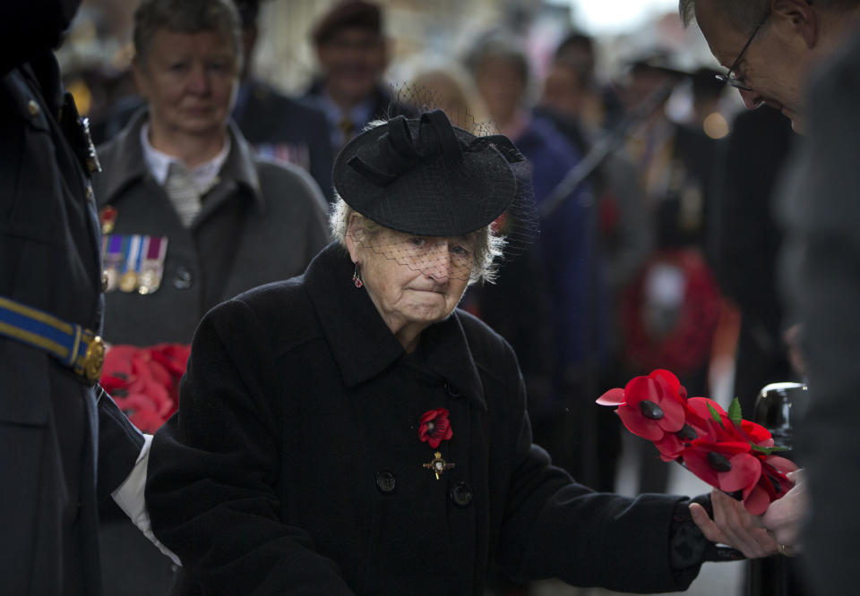 Francesca Shaw, from Leed, England, prepares to lay a poppy wreath during an Armistice ceremony at the Menin Gate in Ypres, Belgium, Sunday, Nov. 11, 2018. Sunday marks exactly 100 years since the end of the First World War. (AP Photo/Virginia Mayo)