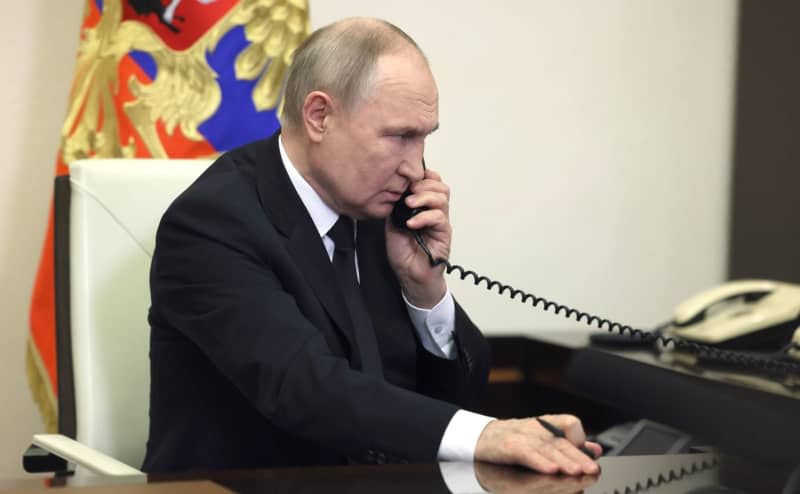 Russian President Vladimir Putin speaks over the phone during his address, the day after a terror attack on the Crocus City Hall in Krasnogorsk. -/Kremlin/dpa