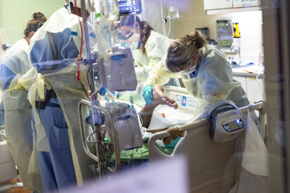 FILE - In this Aug. 31, 2021 file photo medical professionals pronate a 39 year old unvaccinated COVID-19 patient in the Medical Intensive care unit (MICU) at St. Luke's Boise Medical Center in Boise, Idaho. Idaho's public health leaders have expanded health care rationing statewide amid a massive increase in the number of coronavirus patients requiring hospitalization. The Idaho Department of Health and Welfare made the announcement Thursday, Sept. 16, 2021. St. Luke's Health System, Idaho's largest hospital network, asked state health leaders to allow "crisis standards of care" on Wednesday because the increase in COVID-19 patients has exhausted the state's medical resources. (AP Photo/Kyle Green,File)