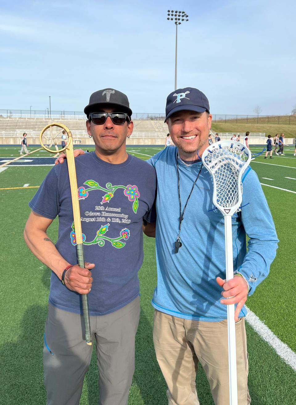 Petoskey varsity lacrosse coach Brian Main (right) and R.J. Smith, of Lac Courte Oreilles Ojibwe (Wis.) and Petoskey Lacrosse board member, got together recently to help teach the history of the game to area players.