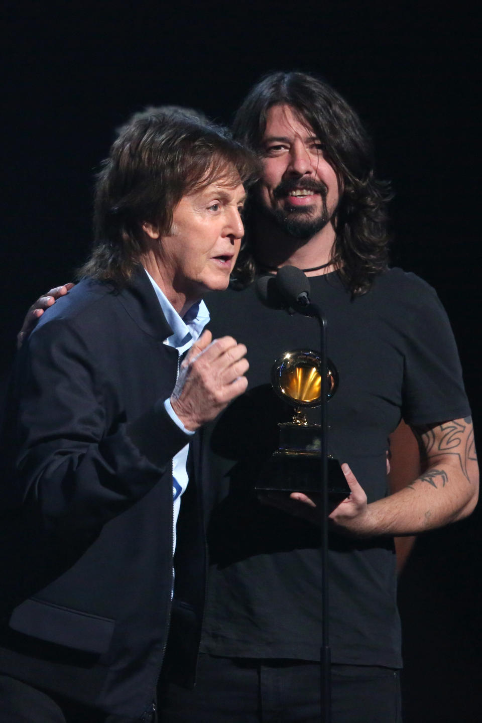 Paul McCartney, left, and Dave Grohl, accept the award for best rock song for Cut Me Some Slack" at the 56th annual Grammy Awards at Staples Center on Sunday, Jan. 26, 2014, in Los Angeles. (Photo by Matt Sayles/Invision/AP)