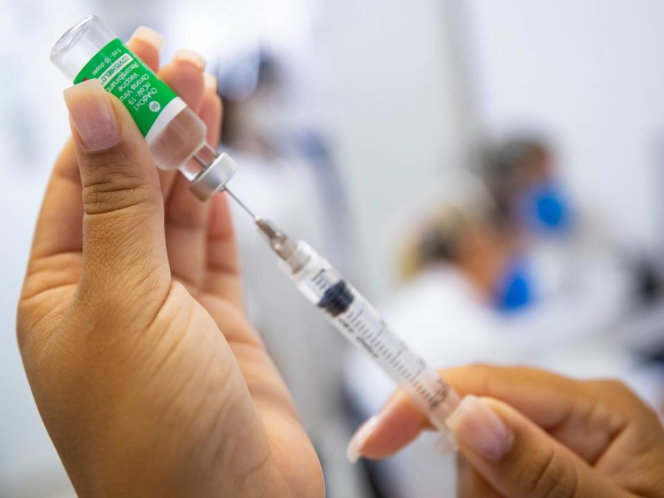 A nurse assistant prepares a dose of the AstraZeneca vaccine (AP/Andre Penner)