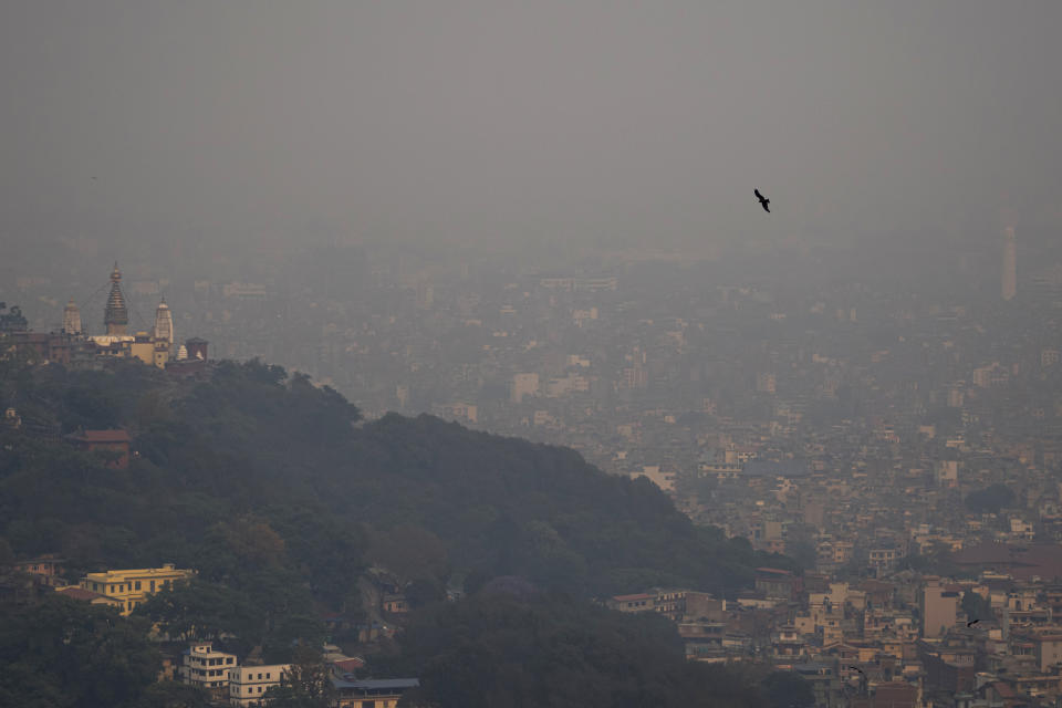 A bird is seen flying as smog envelops the skyline in Kathmandu, Nepal, May 3, 2024. Pollution from buses and other vehicles and from burning fuels for cooking and heating made Kathmandu one of the world's worst polluted cities for several days in April, as the government warned people to stay indoors. (AP Photo/Niranjan Shrestha)