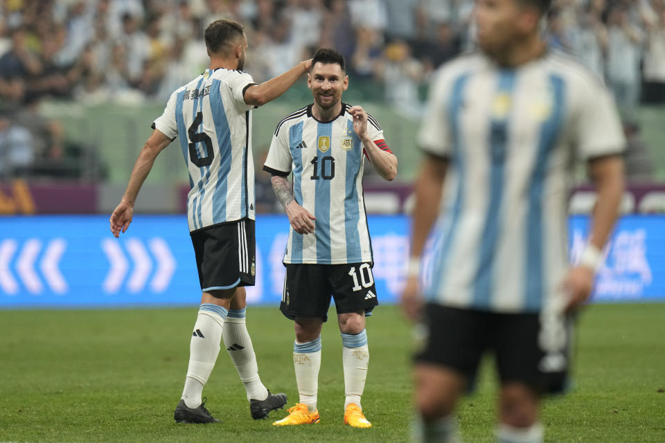 Argentina's Lionel Messi, center, and German Pezzela, left, reacts during during their friendly soccer match against Australia at the Workers' Stadium in Beijing, China, Thursday, June 15, 2023. (AP Photo/Andy Wong)