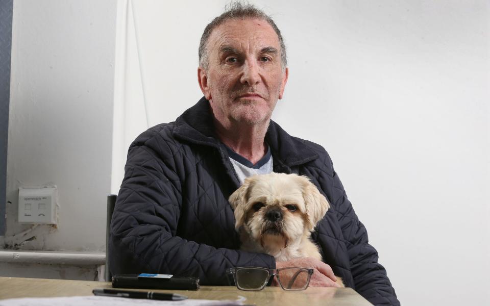 Brian Flynn of Blackley, Greater Manchester looking angry, sat with his dog