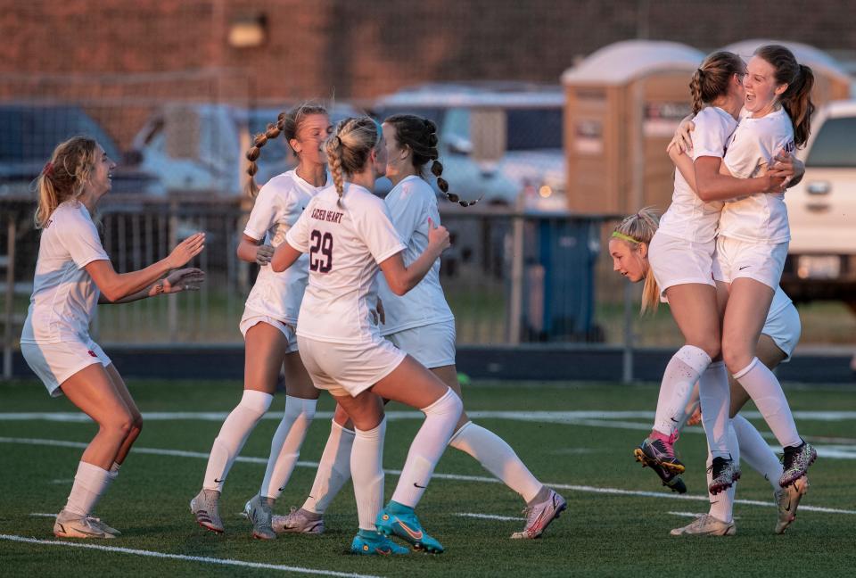 Sacred Heart players celebrate after scoring the tying run in the first half of their match against South Oldham. Aug. 24, 2022