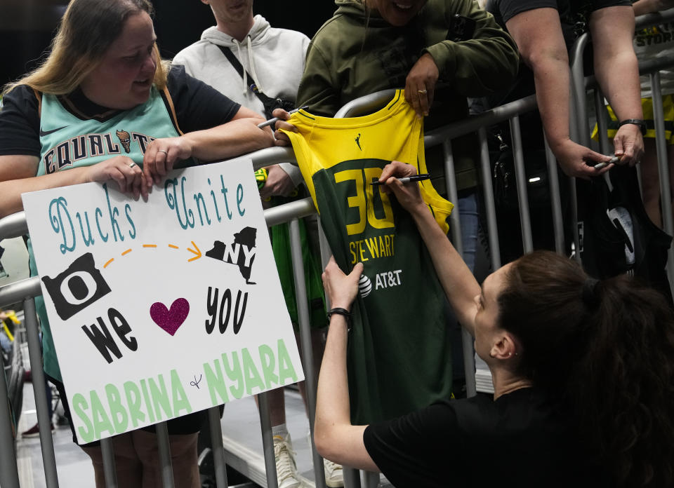 New York Liberty forward Breanna Stewart signs a jersey from her Seattle Storm days before a WNBA basketball game between the Liberty and the Storm, Tuesday, May 30, 2023, in Seattle. (AP Photo/Lindsey Wasson)