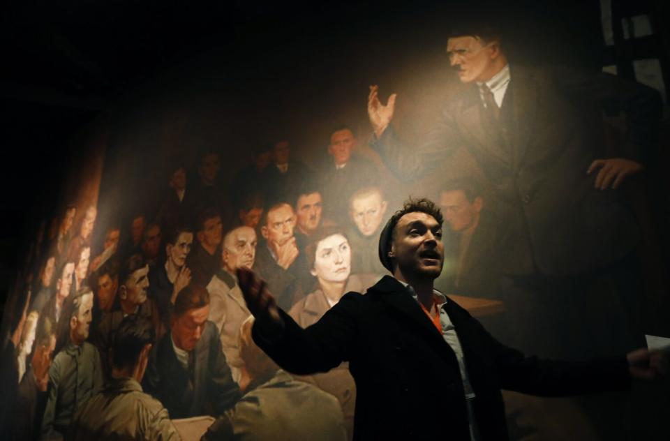 Rabbi Yoshi Zimmerman leads a group of people on a tour through the Museum of Tolerance.