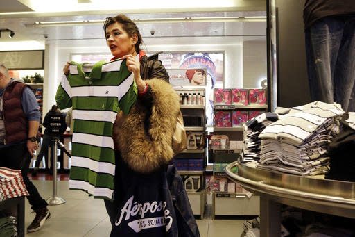 FILE - In this Wednesday, Dec. 2, 2015, file photo, a woman shops in an Aeropostale clothing store, in New York. On Tuesday, Aug. 30, 2016, the Conference Board releases its August index on U.S. consumer confidence. (AP Photo/Mark Lennihan, File)