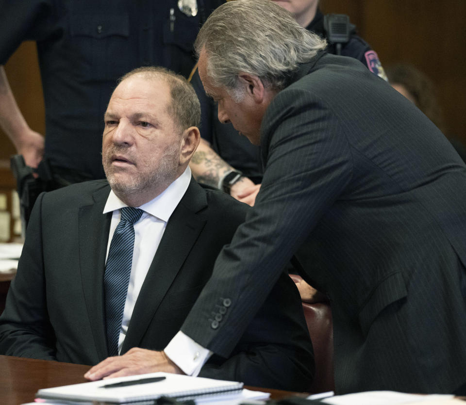 Harvey Weinstein, left, talks with his attorney Benjamin Brafman during his hearing at a courtroom in New York, Thursday, Oct. 11, 2018. Manhattan's district attorney dropped part of the criminal sexual assault case against Weinstein on Thursday after evidence emerged that cast doubt on the account one of his three accusers provided to the grand jury. (Steven Hirsch /New York Post via AP, Pool)