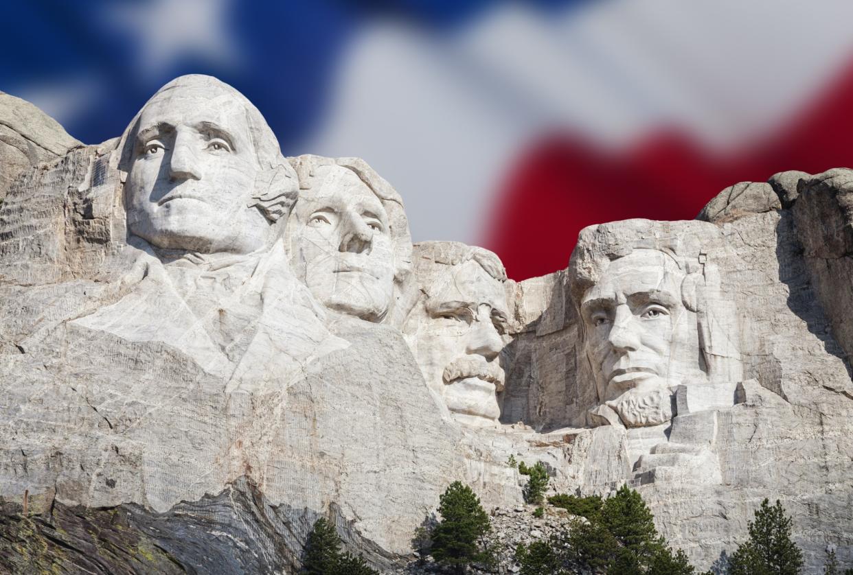 USA, South Dakota, Black Hills, Mount Rushmore National Memorial with American flag in the background