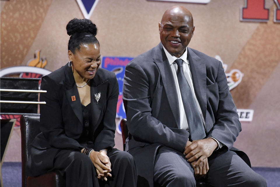 Presenters Dawn Staley and Charles Barkley laugh as they listen to Lindsay Whalen address a gathering during her enshrinement ceremony for the Basketball Hall of Fame, Saturday, Sept. 10, 2022, in Springfield, Mass. (AP Photo/Jessica Hill)