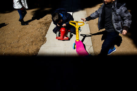 Children play in the yard of the Model National Nursery of Kallithea, in Athens, Greece, March 3, 2017. REUTERS/Alkis Konstantinidis