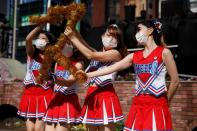 Cheerleaders perform at Shimbashi Station one day before Tokyo 2020 Olympics