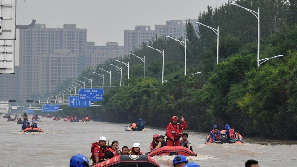 Rescuers use rubber boats to transfer trapped people after days of downpours brought by Typhoon Doksuri on August 2, 2023 in Zhuozhou