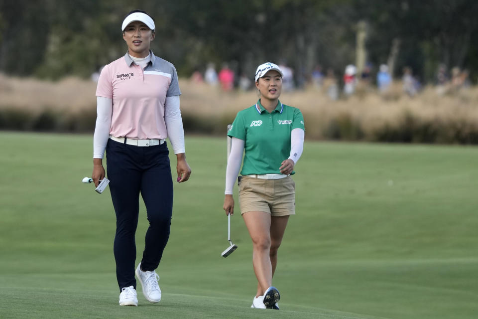 Amy Yang, of South Korea, left, and Minjee Lee, of Australia, right, walk to the 18th green during the third round of the LPGA CME Group Tour Championship golf tournament, Saturday, Nov. 18, 2023, in Naples, Fla. (AP Photo/Lynne Sladky)