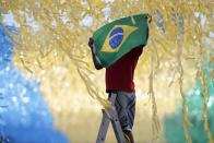 A man is seen working on the decoration of a street for the upcoming World Cup in Brasilia. (Ueslei Marcelino/Reuters)