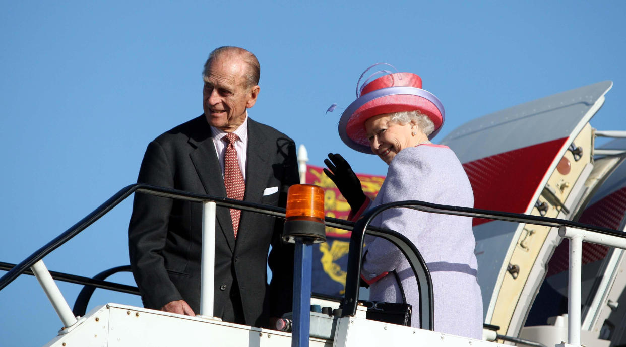 Queen Elizabeth II with the Duke of Edinburgh at Heathrow Airport before boarding a plane ahead of the royal visit to eastern Europe.