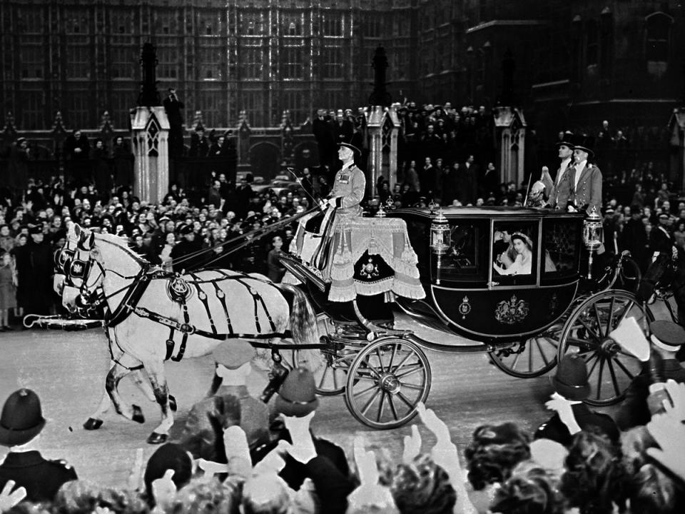 Queen Elizabeth II (in coach) and her husband Prince Philip, Duke of Edinburgh are cheered by the crowd after their wedding ceremony, on 20 November 1947, on their road to Buckingham Palace, London (AFP/Getty)