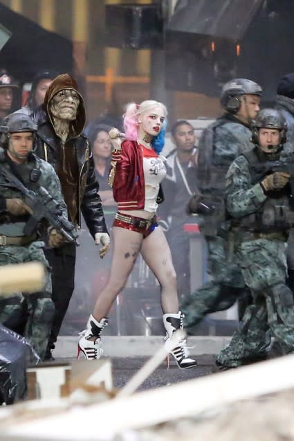 <strong>Margot Robbie </strong>looks totally badass on the set of Suicide Squad! Director <strong>David Ayer</strong> shared the first full cast photo on Sunday, and now we’re getting an even closer look into the colorful world of Harley Quinn. Splash News Robbie can be seen strutting her stuff in full costume on set in Toronto Sunday, complete with a baseball bat, pink and blue dip-dyed pig tails, and a T-shirt that says ‘Daddy’s Lil Monster.' Splash News She’s also sporting plenty of tattoos and a harlequin-themed jacket that reads, ‘Property of Joker.’ <strong>WATCH: Viola Davis on 'Suicide Squad' Role: 'I'm a Little Scared'</strong> For the uninitiated, Harley Quinn is a supervillain originally created for <em>Batman: The Animated Series</em> in 1992. She was once a doctor at Arkham Asylum who became infatuated and soon hopelessly devoted to a twisted relationship with Joker, whom she adoringly calls “Mister J” in her high-pitched, thick Brooklyn accent. Ayer recently shared a photo of Harley’s main man, played by <strong>Jared Leto</strong>. Robbie will star alongside Leto, <strong>Will Smith </strong>(Deadshot), <strong> Joel Kinnaman</strong> (Rick Flagg), <strong> Jai Courtney </strong>(Boomerang), <strong>Cara Delevingne </strong>(Enchantress), <strong>Adewale Akinnuoye-Agbaje</strong> (Killer Croc) and <strong>Viola Davis </strong>(Amanda Waller). The film will follow a group of supervillains, tasked with executing a dangerous and likely fatal mission to have their criminal slates wiped clean. <em>Suicide Squad</em> is scheduled to hit theaters in August 2016. <strong> Follow Ashley on Twitter: @AshCrossan </strong>