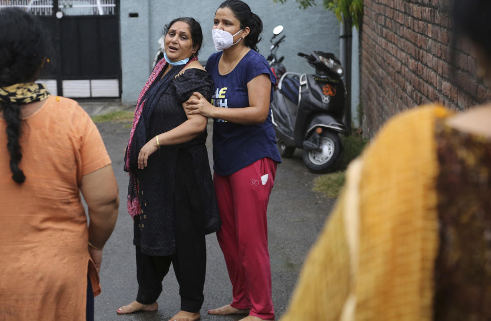 Relatives of Rakesh Pandita, a politician who was killed late Wednesday, mourns at their residence in Jammu, India, Thursday, June.3, 2021. Assailants fatally shot the politician belonging to India’s ruling party in disputed Kashmir, police said Thursday, blaming separatist rebels for the attack. The unidentified assailants fired at Pandita late Wednesday in the southern town of Tral, where he was visiting a friend, police said. He was declared dead in a hospital. (AP Photo/Channi Anand)