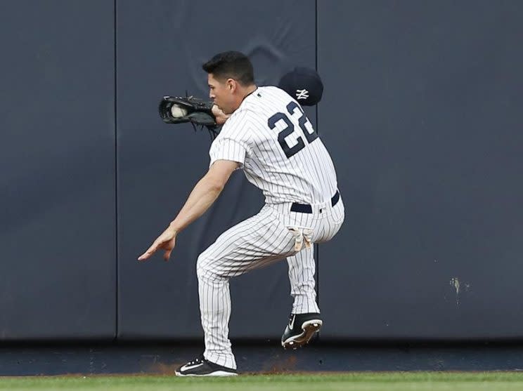 Yankees center fielder Jacoby Ellsbury steadies himself after colliding with the outfield wall making a great catch. He was later diagnosed with a concussion and sprained neck. (AP)